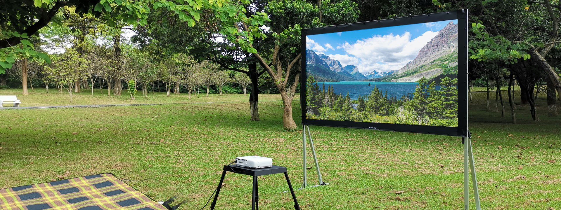 Portable screenpro screen with projector display in a park.